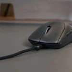 Chuột không dây Alienware Pro đang được cắm sạc qua cổng USB-C, minh họa việc kiểm tra và thay pin chuột.