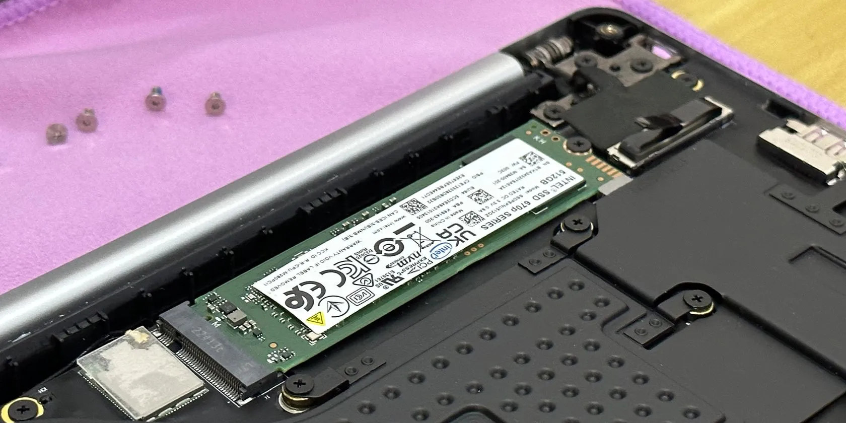 Khe cắm SSD trong một chiếc laptop Tecno Megabook T1 với các vít Torx xung quanh, minh họa vị trí lắp đặt ổ NVMe.