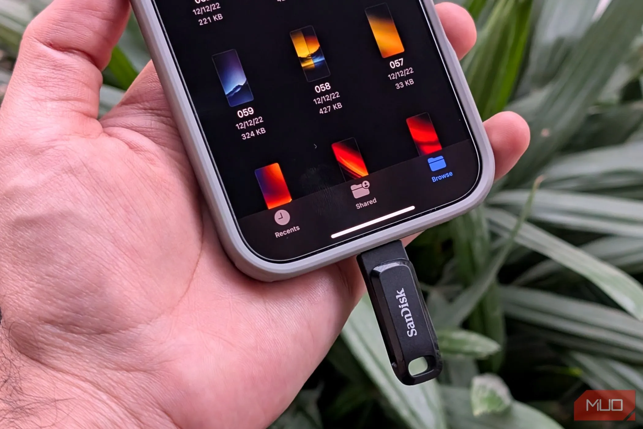 Một ổ đĩa flash USB-C được kết nối với iPhone, minh họa nguy cơ lây nhiễm malware từ các thiết bị lưu trữ ngoài khi chia sẻ.