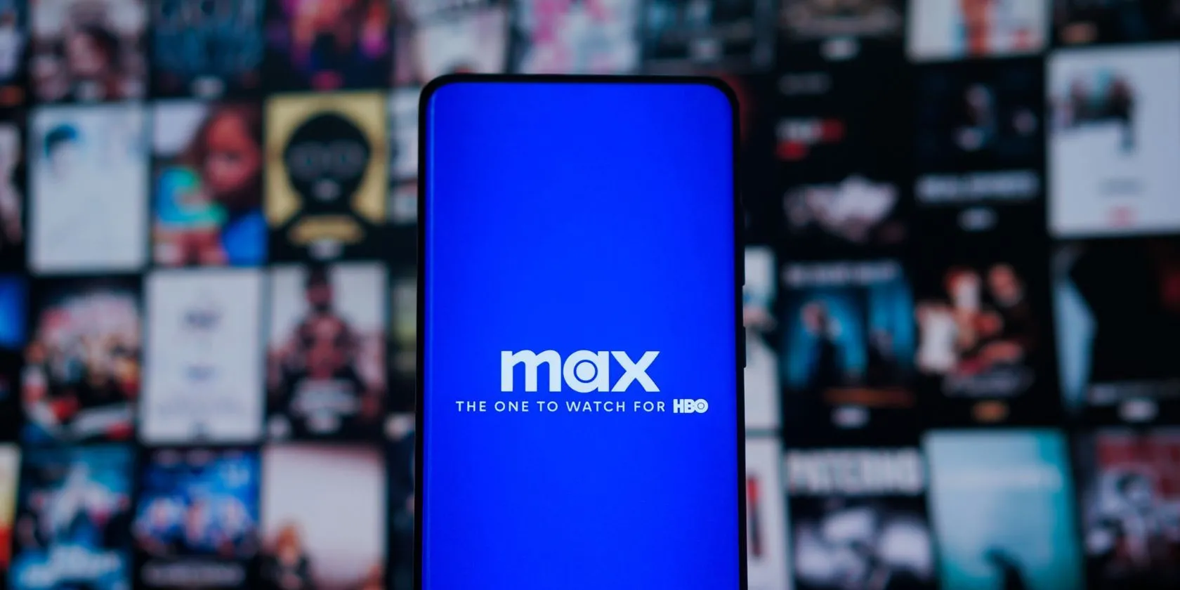 Người dùng đang xem logo Max trên điện thoại trước màn hình TV