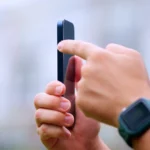 Người dùng thao tác nút Action Button trên iPhone 15 Pro, minh họa các tính năng thừa thãi trên điện thoại cao cấp