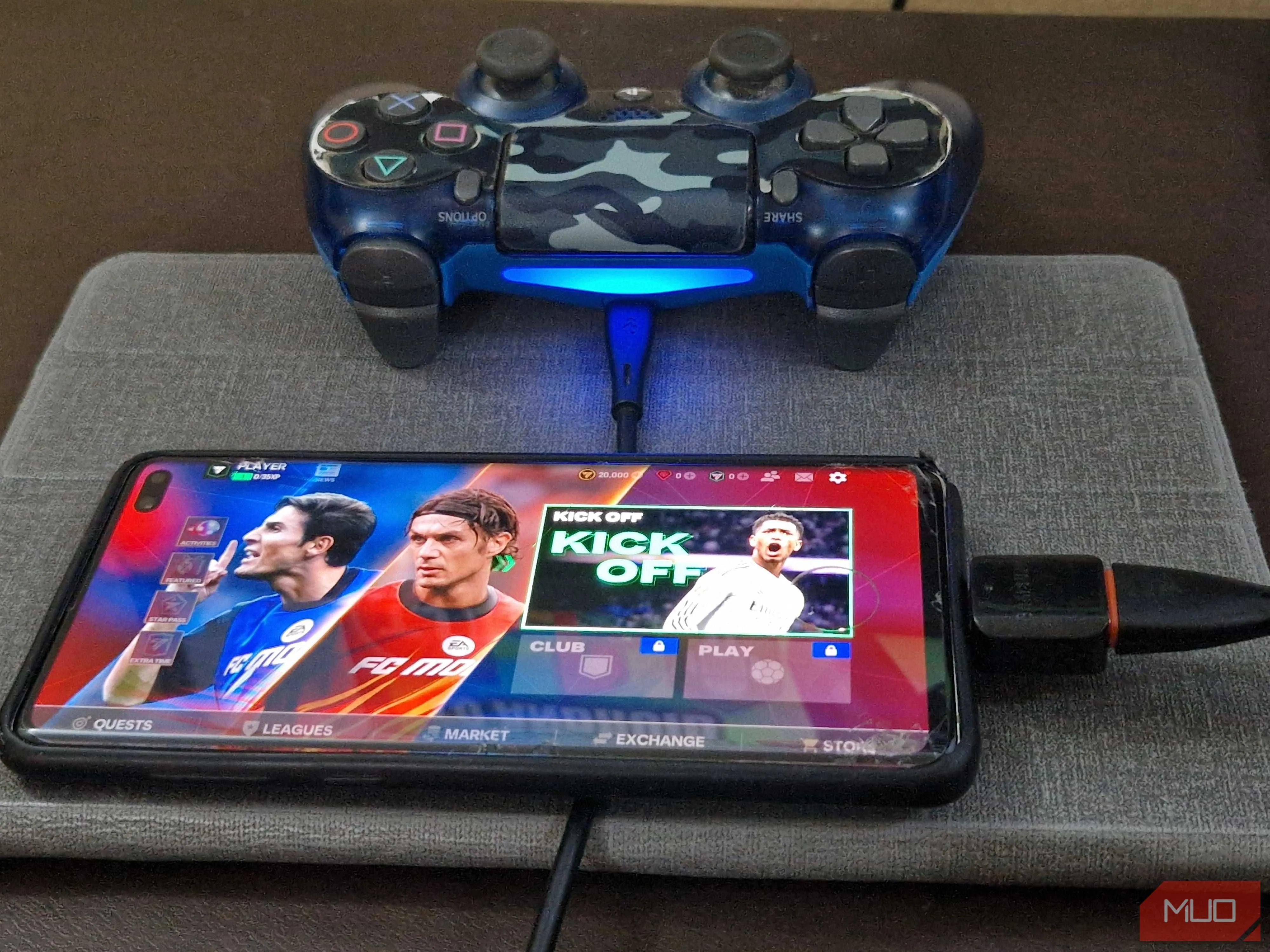 Tay cầm PS4 được cắm vào smartphone qua bộ chuyển đổi OTG và cáp USB, tăng trải nghiệm chơi game di động